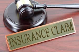 A gavel with the words "Insurance Claim"