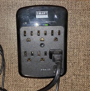 Surge protected multiple outlet plug