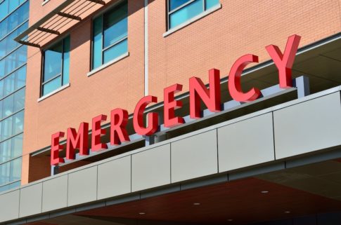 An emergency room sign. This article explains what you should know to get help on the road.