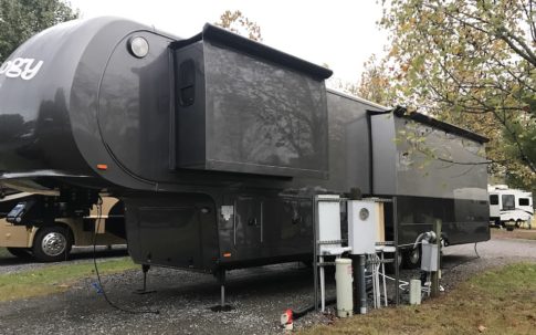 A large black king-size RV