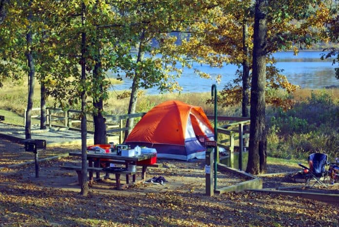 A tent and picnic table in a campground