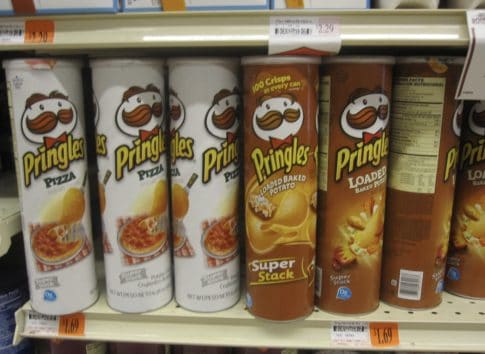 A shelf of Pringles cans at a grocery store