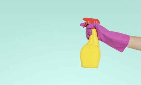 A woman holds a squirt bottle as she gets ready to clean an RV