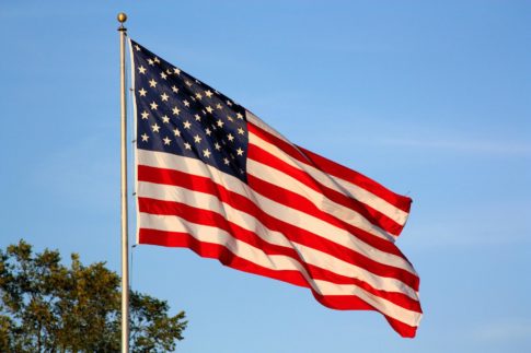 An American flag blows in the wind at presidential libraries in flyover country