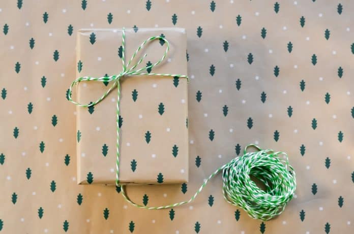 A present wrapped in christmas tree wrapping paper