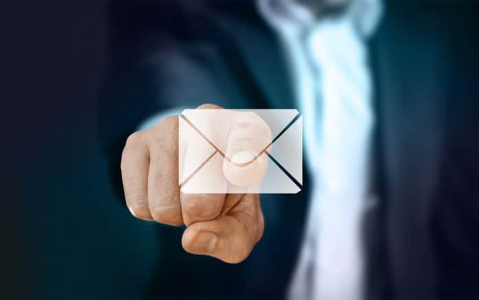 A finger pointing to an email symbol