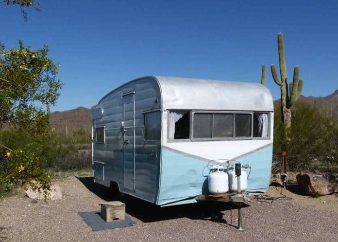 A vintage blue and white Shasta travel trailer