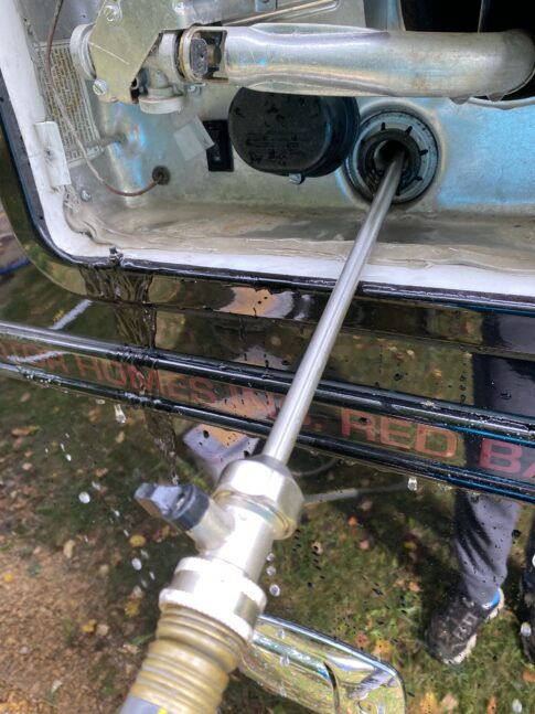A RV water heater tank rinser going into the water tank