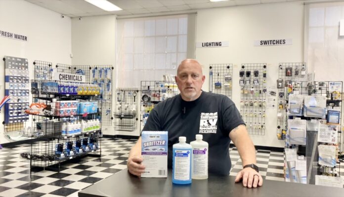 Dustin Simpson sits at a table reminding you to clean your RV's fresh water tank every six months