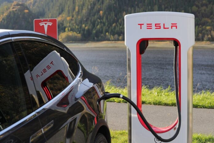 A tesla at a charging station