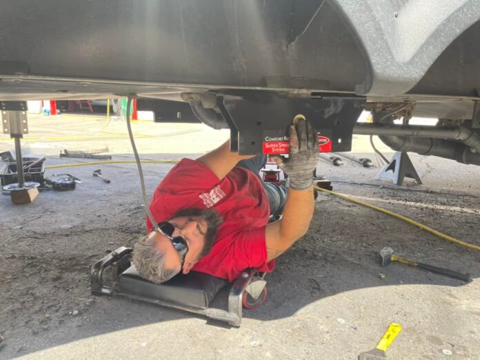 An RV tech installing the Roadmaster Comfort Ride System