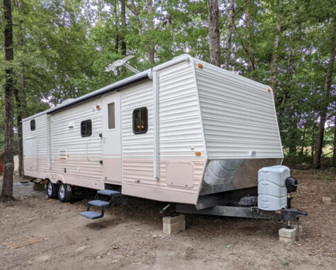 A pink and white paint job on a travel trailer during an RV renovation