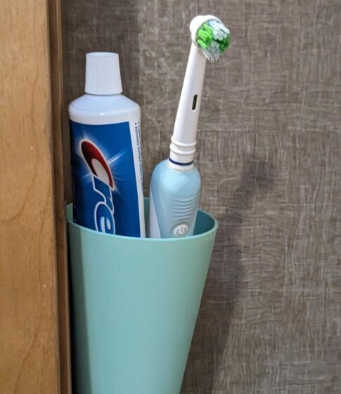 dental items find storage on the side of bath cabinet