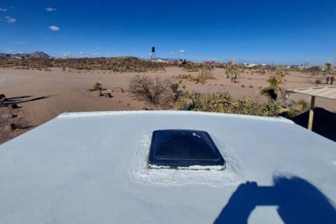 Edging coat during resealing an EPDM roof on an RV.