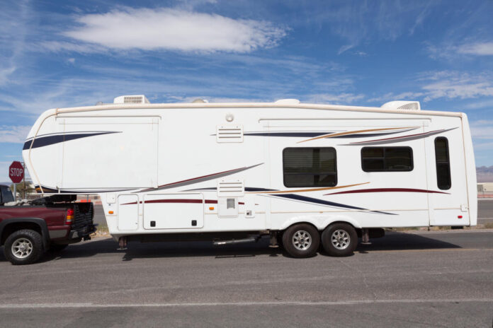 Caravan trailer on road with blue sky
