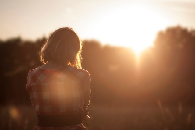 Pixabay lonely woman sitting outdoors by herself.