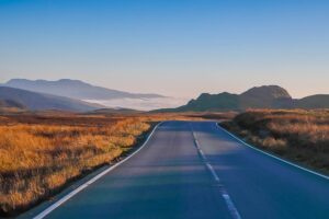 highway with mountains in background Pixabay
