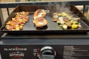 food cooking on a portable Blackstone griddle