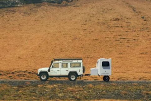 hitch otel tiny telescoping travel trailer being towed by a Jeep