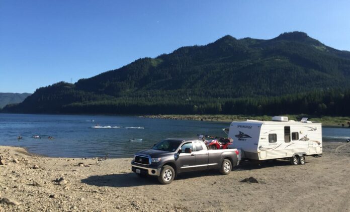 RV parked by lakeside campground