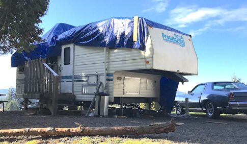 motorhome covered with blue tarp