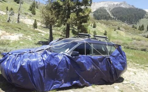 car wrapped in blue tarp