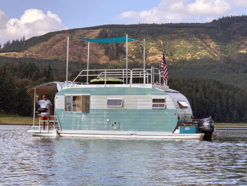 A vintage trailer houseboat floats on Lake Shasta