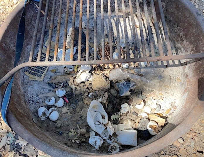 Trash in campfire pit