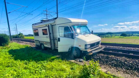 RV stranded on railroad tracks