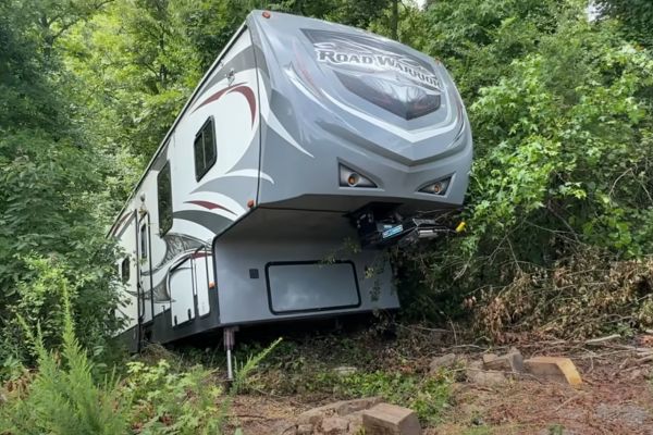 extreme off-rod recovery 5th wheel sliding down a hillside