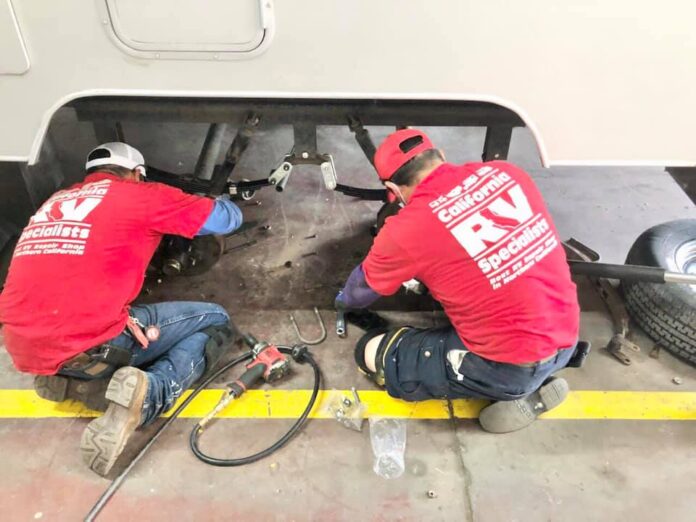 A crew working on installing a Roadmaster Comfort Ride System