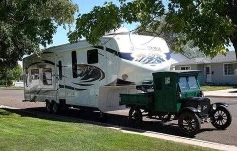 Old truck towing fifth wheel trailer