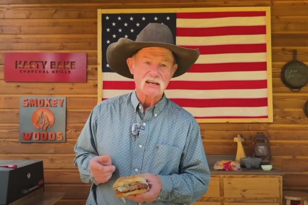 Cowboy Kent Rollins holding an old fashioned Slugburger.