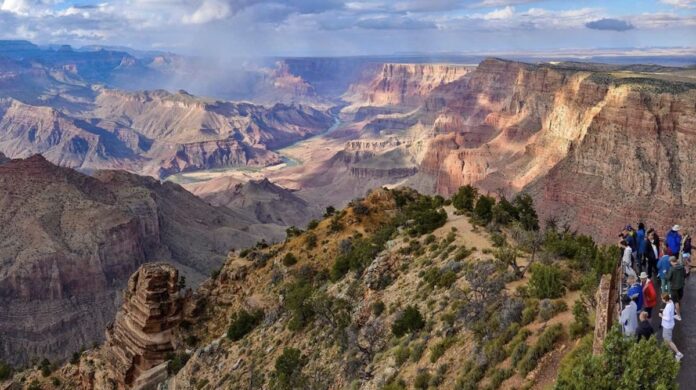Tourists stand at Grand Canyon overlook