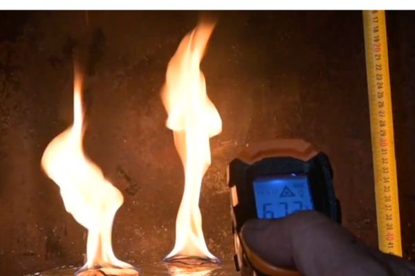 Fire built with DIY fire starters being tested for size and heat