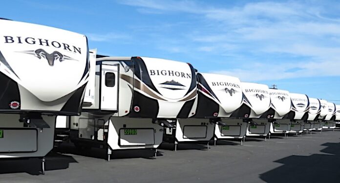 New fifth wheel trailers lined up in a row
