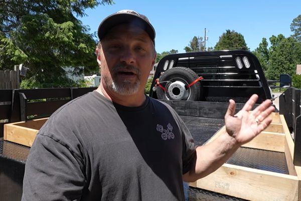 Flat bed truck to truck camper post photo showing a flatbed truck and the host from the Runaway Roses.