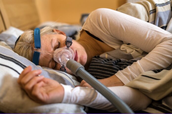 Woman sleeps with CPAP machine