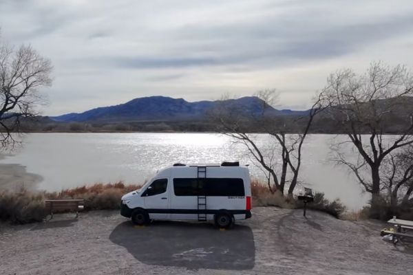 RV at a state park campground - title card for why to choose national and state parks over boondocking